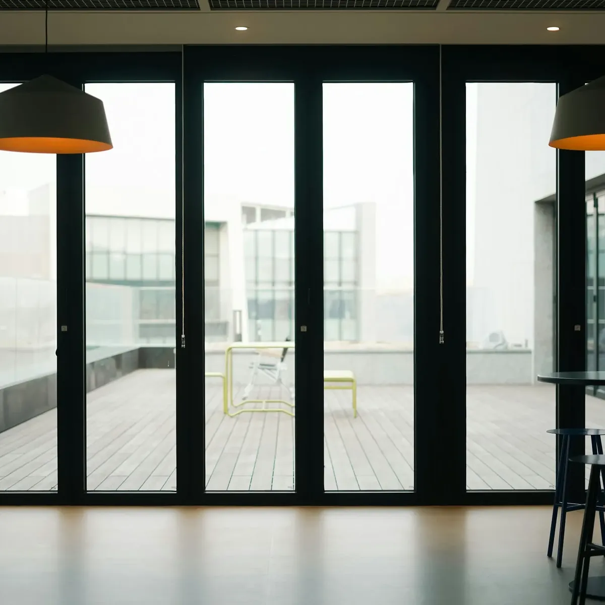 Slim black aluminium framed bifold doors in a bright open-plan room